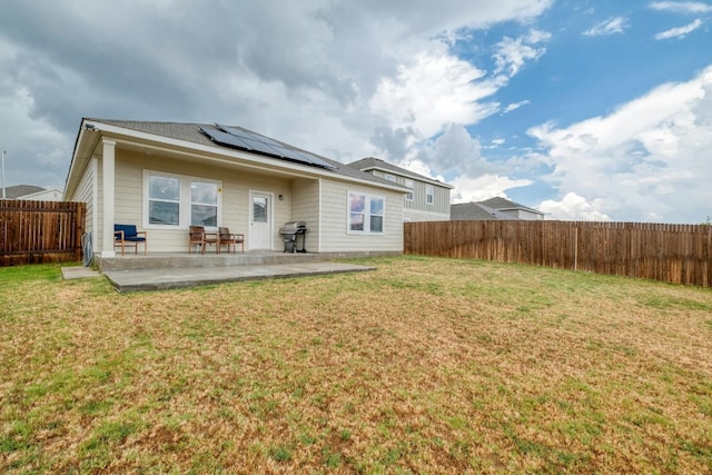 14601 Shooter Mc Gavin Dr, Manor, TX 78653 - rear view of house featuring a patio, roof mounted solar panels, and a fenced backyard