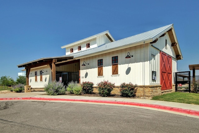 14601 Shooter Mc Gavin Dr, Manor, TX 78653 - view of front of house with board and batten siding and a metal roof