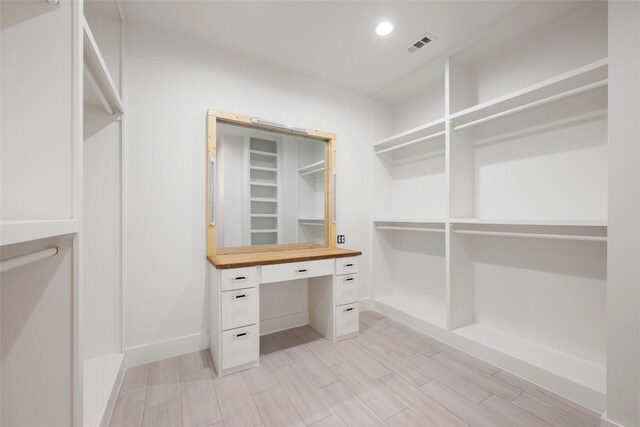 walk in closet featuring light hardwood / wood-style flooring