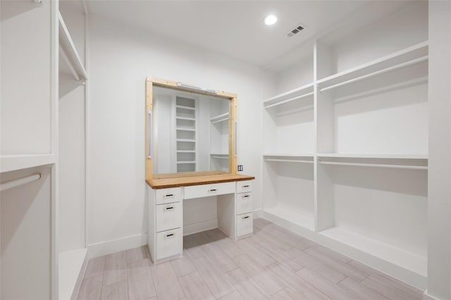 walk in closet with visible vents and wood tiled floor