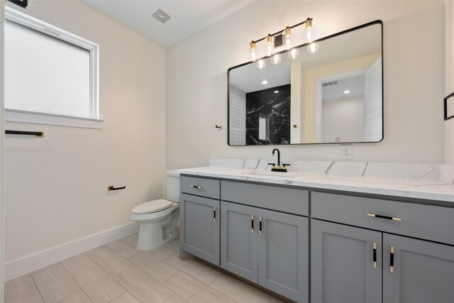 bathroom featuring toilet and vanity