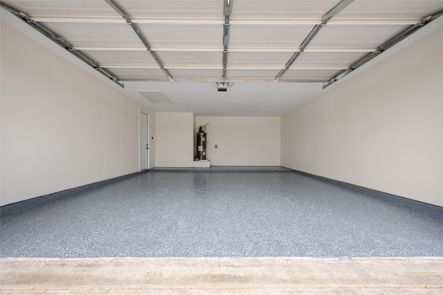 garage featuring electric water heater and a garage door opener