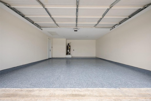 garage with a garage door opener, baseboards, and strapped water heater