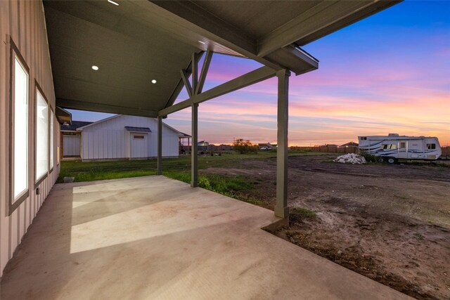 view of patio terrace at dusk