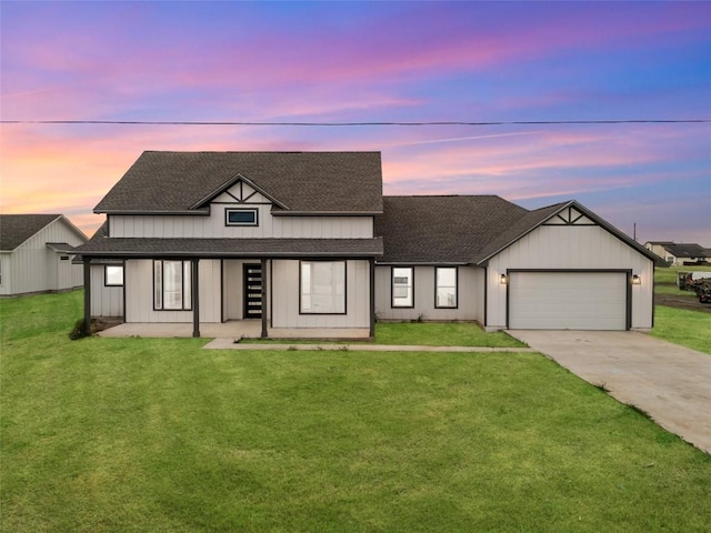 view of front of house featuring a garage and a lawn