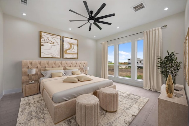bedroom featuring baseboards, light wood-style flooring, visible vents, and recessed lighting