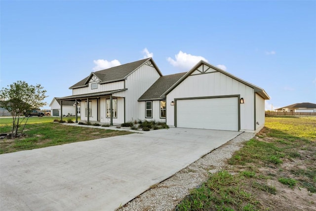116 Bianca Cir, Del Valle, TX 78617 - modern farmhouse featuring a garage, concrete driveway, a front lawn, a shingled roof, and a porch