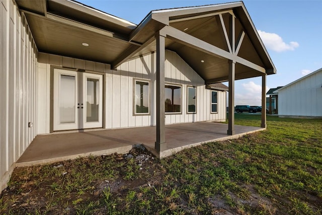 116 Bianca Cir, Del Valle, TX 78617 - rear view of house featuring board and batten siding, a patio, and a yard