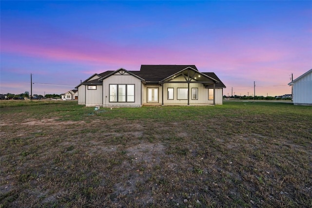 116 Bianca Cir, Del Valle, TX 78617 - back of property at dusk with a lawn