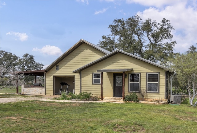 view of front of property with a front yard and central AC unit