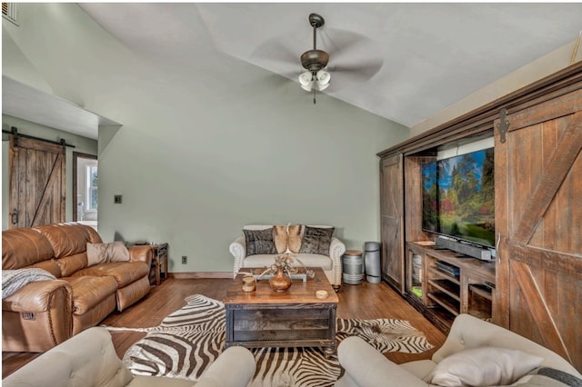 1619 Althaus Ranch Rd, Johnson City, TX 78636 - living area featuring a barn door, ceiling fan, wood finished floors, and high vaulted ceiling