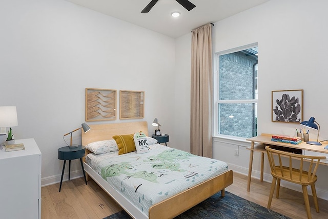 bedroom with hardwood / wood-style flooring, multiple windows, and ceiling fan