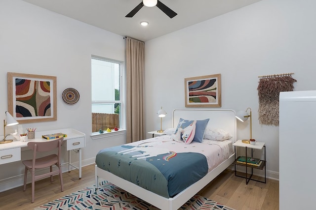 bedroom with light hardwood / wood-style flooring and ceiling fan