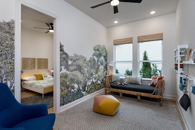 living area with hardwood / wood-style flooring and ceiling fan