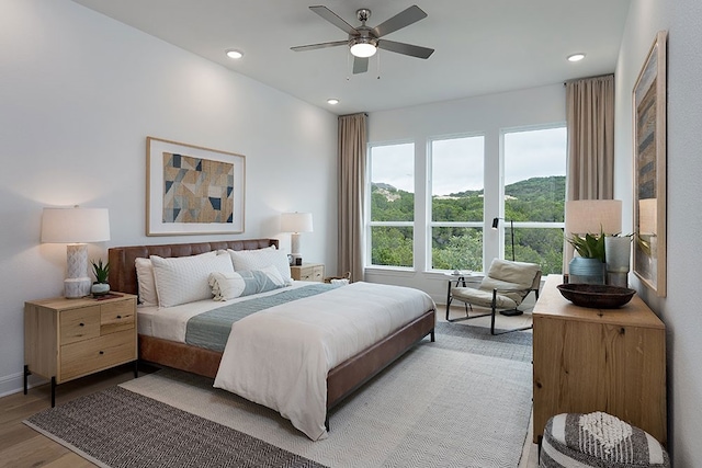 bedroom with hardwood / wood-style flooring and ceiling fan