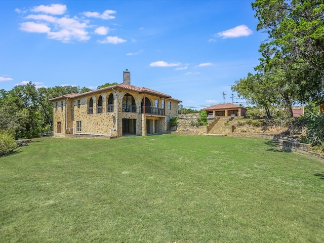 rear view of house with a yard