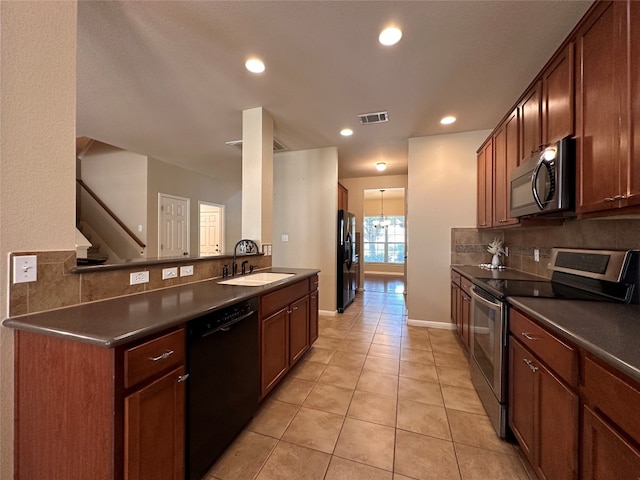 kitchen featuring kitchen peninsula, tasteful backsplash, sink, black appliances, and light tile patterned floors