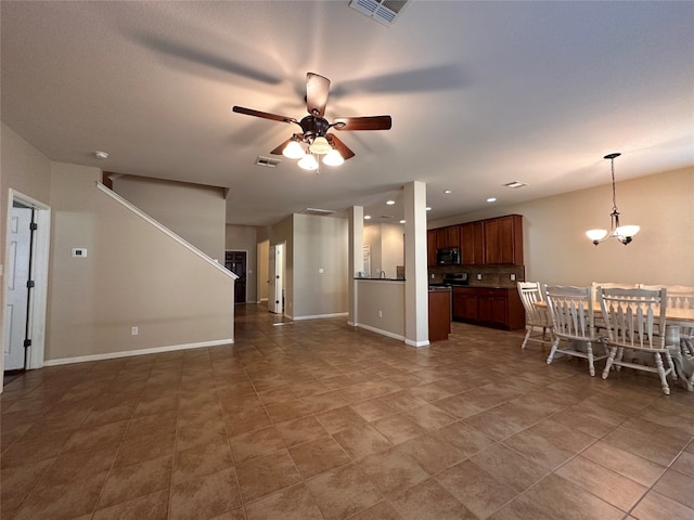 living room featuring ceiling fan with notable chandelier and tile patterned floors