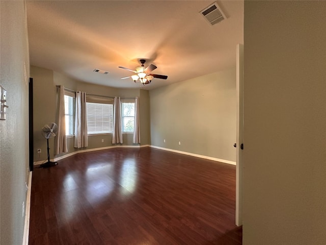 unfurnished room with dark hardwood / wood-style floors and ceiling fan