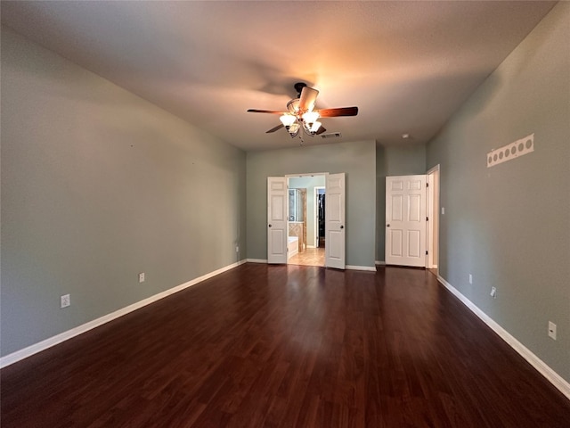 empty room featuring dark hardwood / wood-style floors and ceiling fan