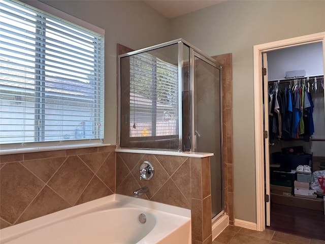 bathroom featuring tile patterned floors and plus walk in shower