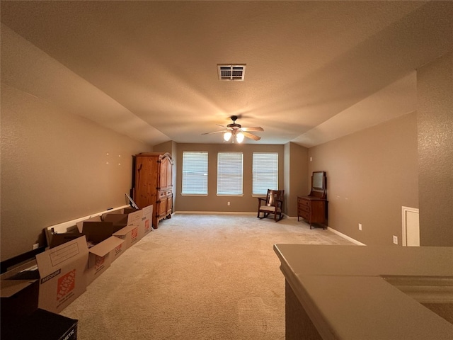 additional living space featuring carpet, a textured ceiling, vaulted ceiling, and ceiling fan