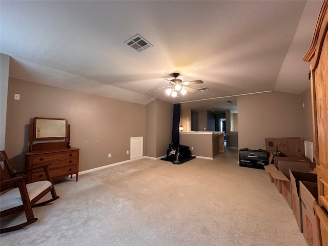 sitting room with a textured ceiling, ceiling fan, light colored carpet, and lofted ceiling