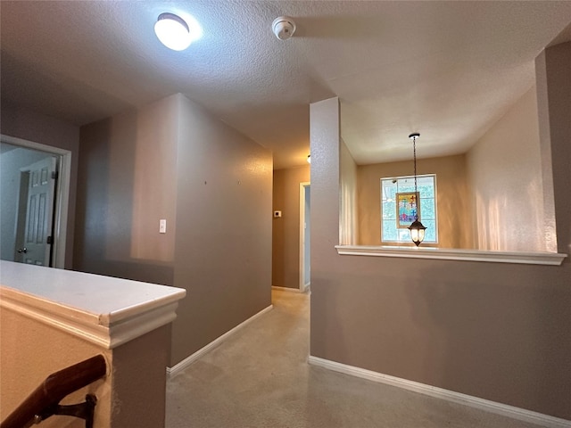 hallway featuring a textured ceiling