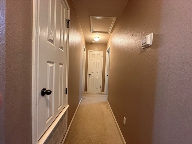 hallway with light colored carpet