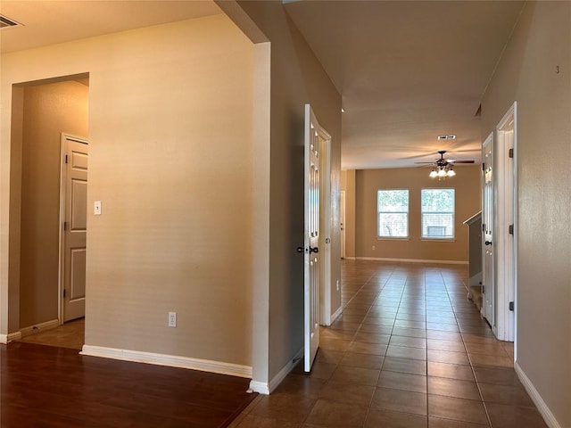 hallway with dark tile patterned floors