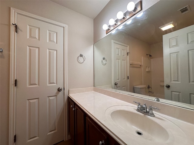 bathroom featuring vanity and toilet