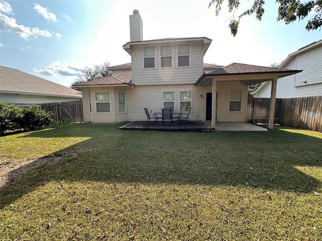 rear view of house with a yard and a patio