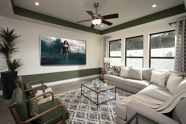 living room with hardwood / wood-style flooring and ceiling fan