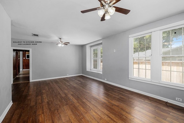 spare room featuring ceiling fan and dark hardwood / wood-style floors