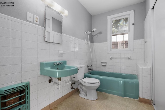 full bathroom with toilet, bathtub / shower combination, heating unit, sink, and tile walls