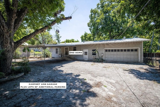 ranch-style home with a garage and a carport