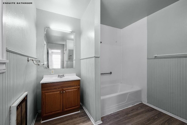 bathroom with hardwood / wood-style flooring, radiator, and vanity