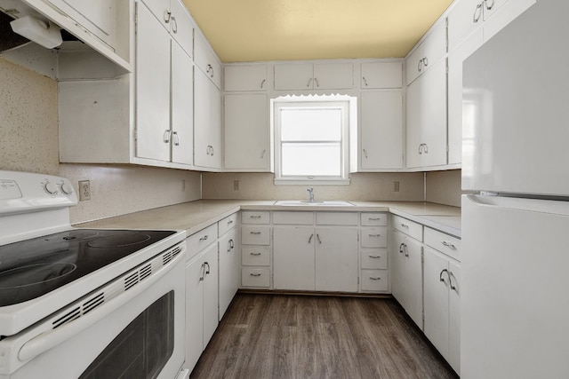 kitchen featuring dark wood-type flooring, white appliances, and white cabinetry