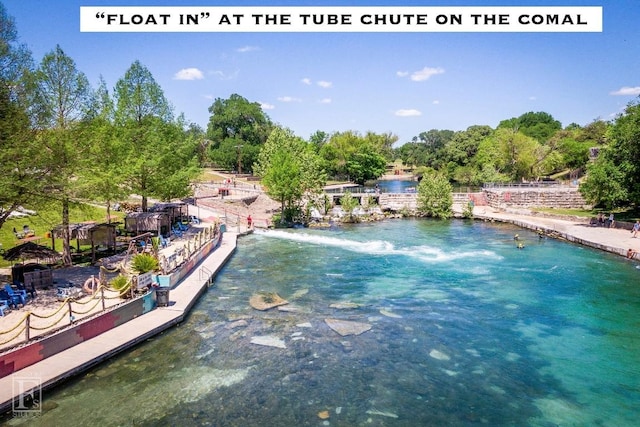 view of swimming pool featuring a water view