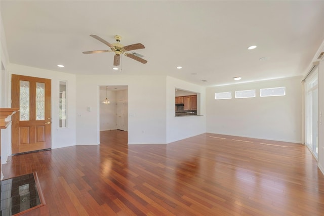 unfurnished living room featuring wood-type flooring and ceiling fan