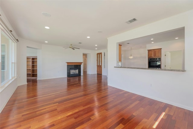 unfurnished living room featuring dark hardwood / wood-style flooring and ceiling fan