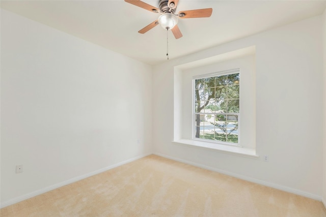 carpeted empty room with plenty of natural light and ceiling fan