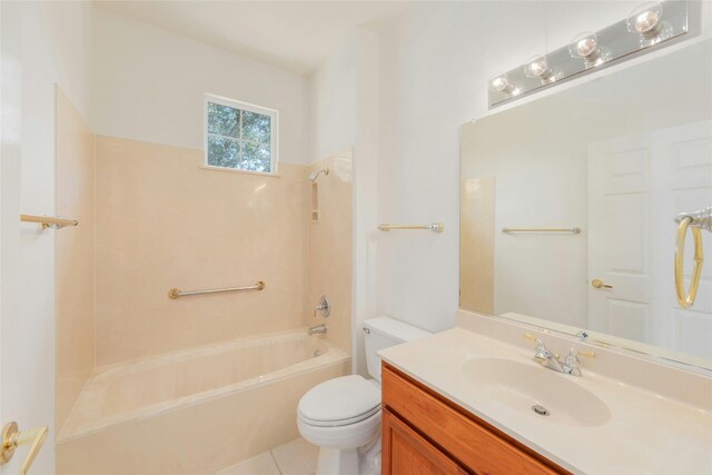 full bathroom with washtub / shower combination, tile patterned flooring, toilet, and vanity