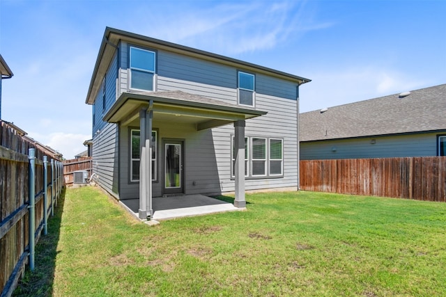 rear view of property featuring a lawn, a patio area, and central air condition unit