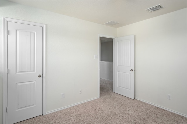 unfurnished bedroom with light colored carpet