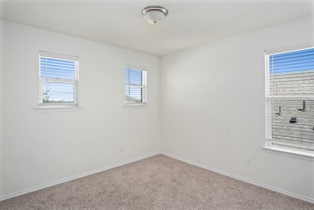 unfurnished room featuring light colored carpet