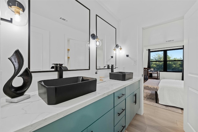 bathroom with vanity and wood-type flooring