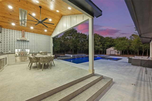 pool at dusk featuring grilling area, a patio area, and ceiling fan