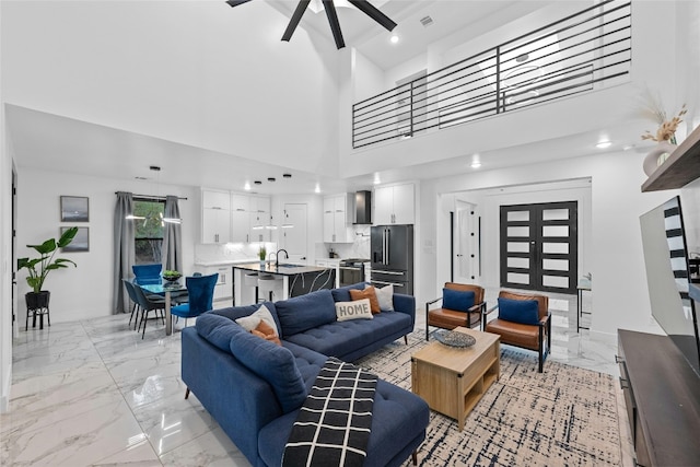 living room featuring ceiling fan and sink