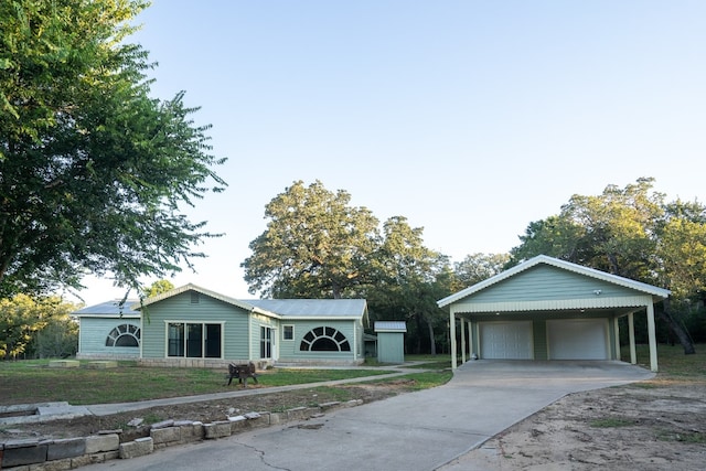 view of front of house featuring a garage and a carport